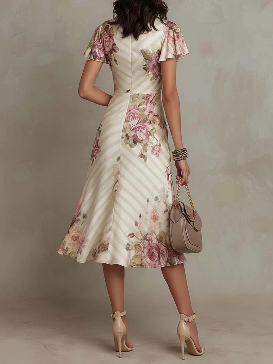 Stilvolles Damen Midi-Kleid mit Blumenmuster & Wickeloptik. Elegantes festliches Kleid für Hochzeitsgäste.