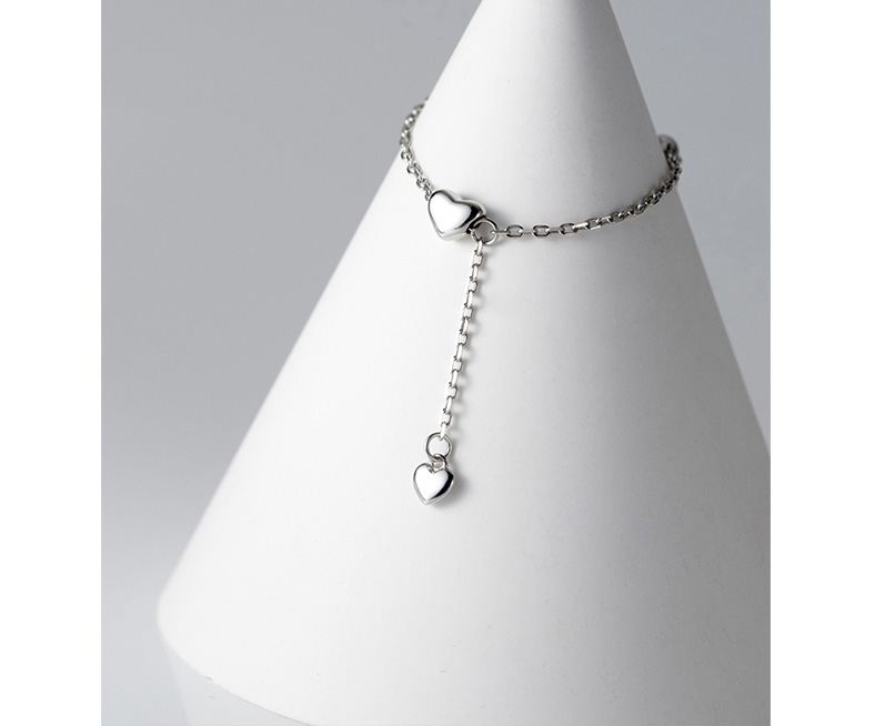 Einzigartiger Damenring mit Herzmotiv & fließenden Quasten, aus hochwertigem Silber.