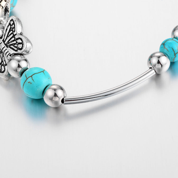 Exklusives Damen Armband: Türkisperlen, Sterlingsilber und ein filigraner Schmetterling – Eleganz pur.