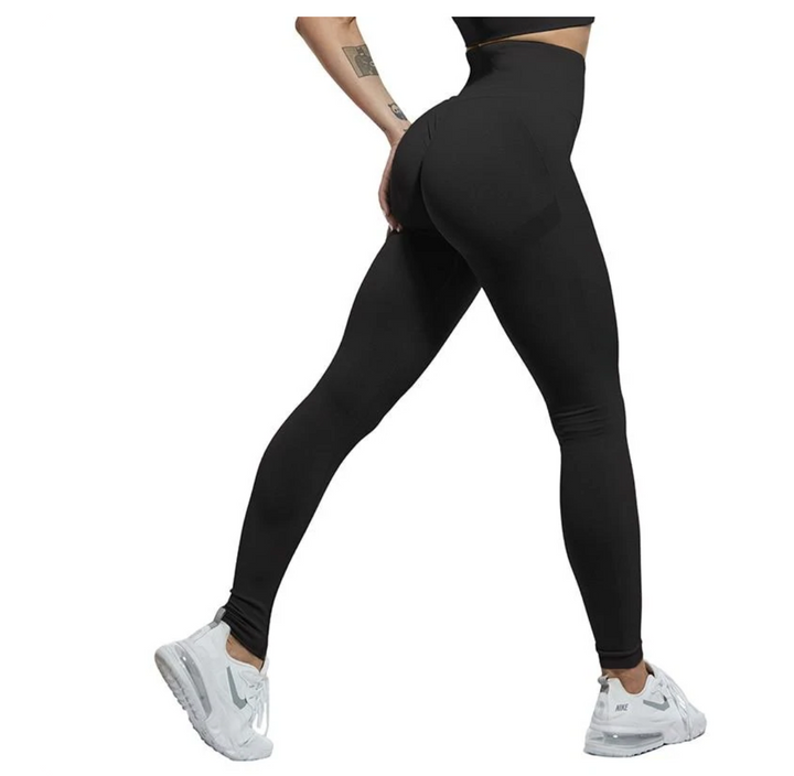 Modell in dunkelgrauer High Waist Shaping Leggings, mit Po-Lift & Kompression, ideal für Yoga & Fitness.