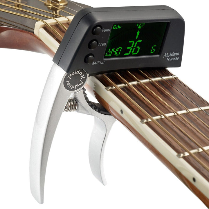 Vielseitiges Stimmgerät & Capo für Saiteninstrumente wie Gitarre, Ukulele und Bass; unverzichtbar für Musiker.