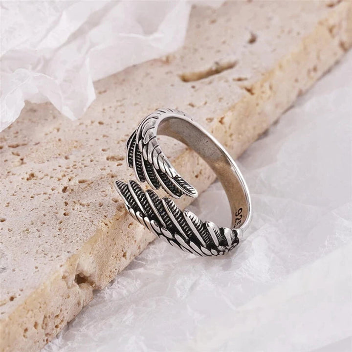 Detailaufnahme des verstellbaren Unisex-Federflügelrings aus glänzendem 925er Silber, filigran gearbeitet.