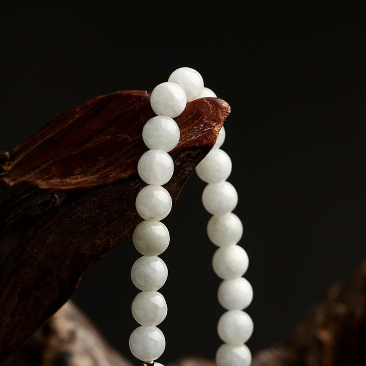Nahaufnahme des handgemachten Unisex Glücksarmbands mit glänzenden Jade- & Achatperlen. Natürlicher Edelsteinschmuck.
