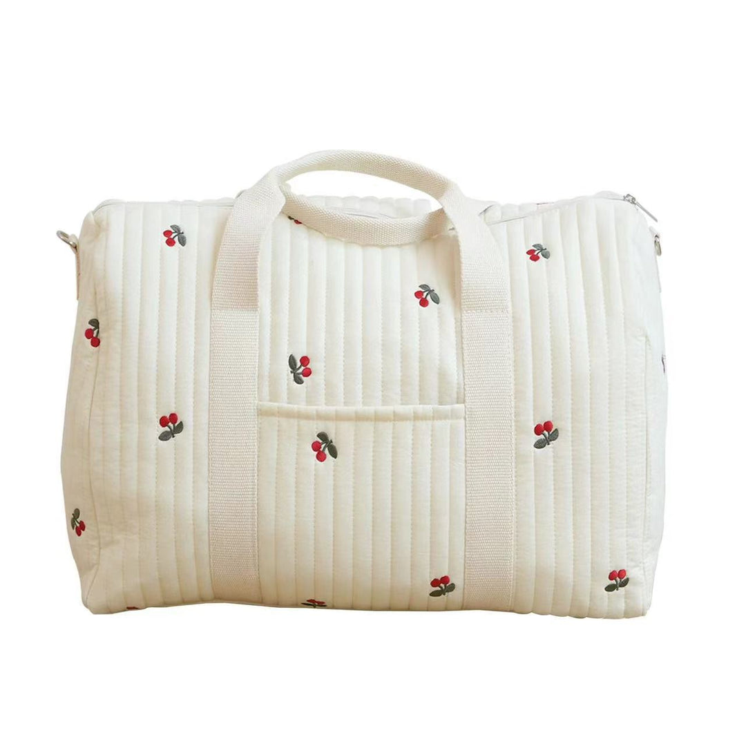 Handliche Wickeltasche mit Tragegriffen, ein kompakter Organizer für Babyzubehör unterwegs.