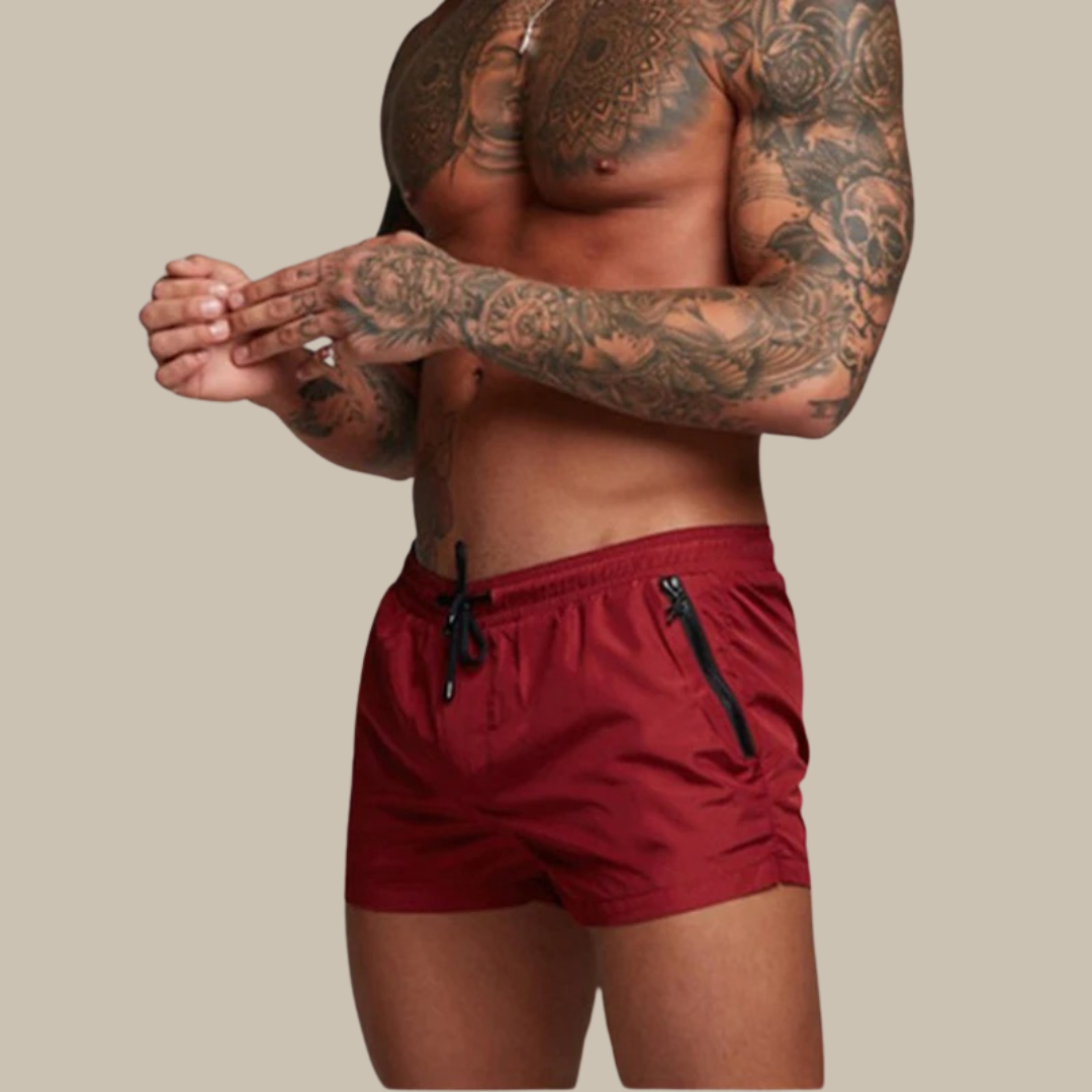 Mann trägt schnelltrocknende Herren Stretch Shorts beim Sport. Perfekte kurze Hose für aktive Freizeit.