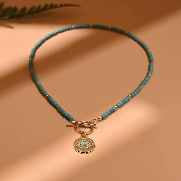 Damen Modeschmuck Choker-Halskette mit Evil Eye Anhänger und runden Perlen.