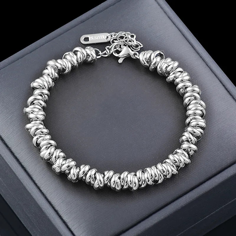Nahaufnahme des Damenschmuck Kettenarmbands mit runden goldenen Perlen und feinen Kettengliedern.