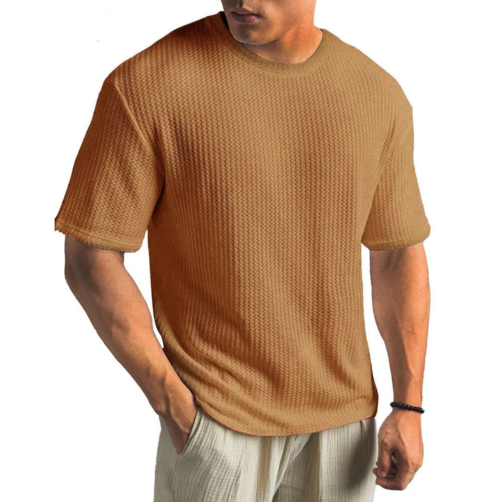 Nahaufnahme des atmungsaktiven Herren T-Shirts. Zeigt die moderne Struktur-Optik des vielseitigen Stoffes.