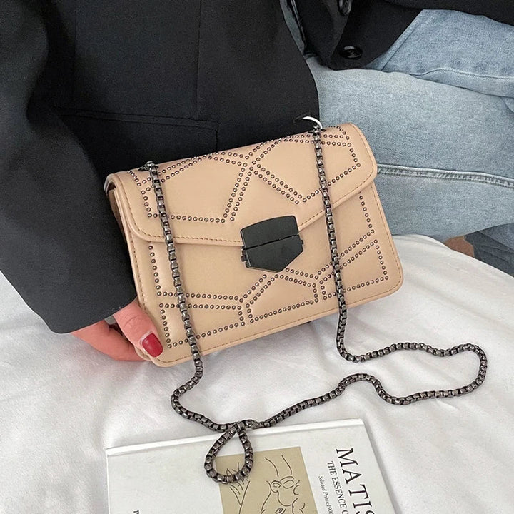 Kompakte Statement Tasche für Damen mit Nieten. Als Crossbody oder Schultertasche tragbar, ein Must-have Accessoire.