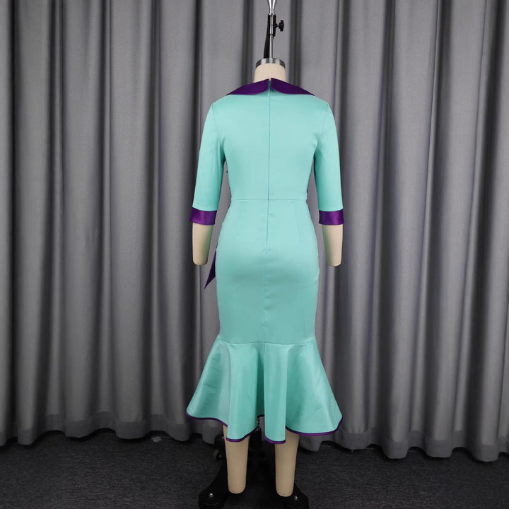 Modisches Damenkleid in Grün, elegant tailliert, mit stilvollem Kragen & asymmetrischer Rocklinie.