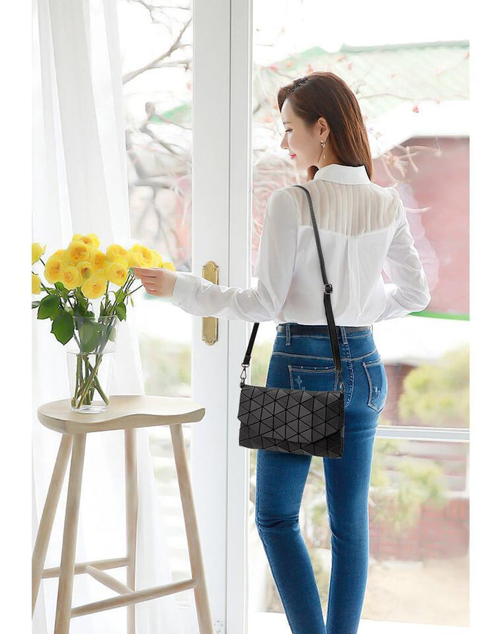 Damen Schultertasche in geometrischem Design, matt, aus Polyester/PVC, getragen als stilvolles Accessoire.