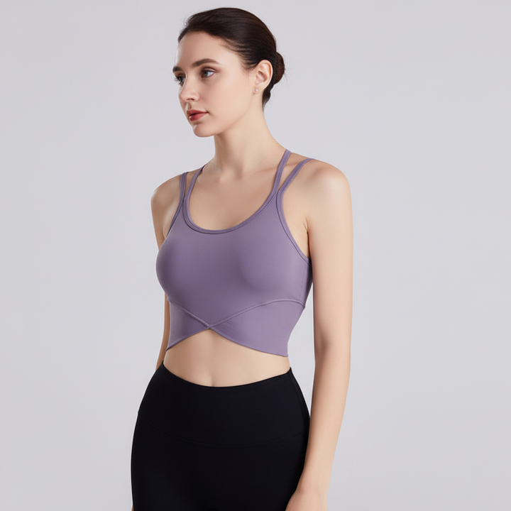 Vorderansicht kurzes Damen Sportoberteil mit Kreuzträgern. Modernes Design für Fitness, Gym & Sportbekleidung.
