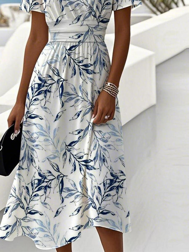 Blumiges Damen Midi-Kleid mit Kurzarm und schmeichelhaftem V-Ausschnitt. Ein stilvolles Freizeitkleid für warme Tage.