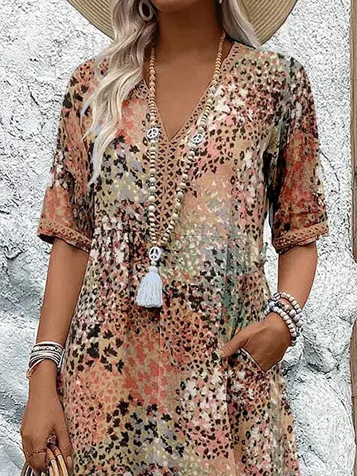 Elegantes Damen Midi-Sommerkleid mit V-Ausschnitt und farbenfrohen Mustern. Leicht & luftig für warme Tage.