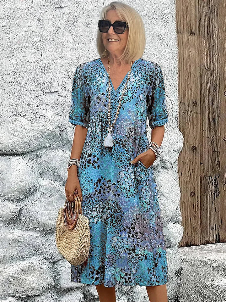 Damen Midi-Kleid mit V-Ausschnitt und sommerlichen Prints, Kurzarm. Bequemes Freizeit- und Urlaubskleid.
