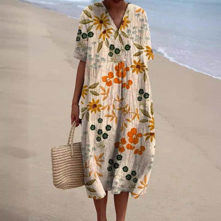 Elegantes Damen Sommerkleid mit fröhlichem Blumenmuster, V-Ausschnitt und kurzen Ärmeln. Perfekt für Freizeit.