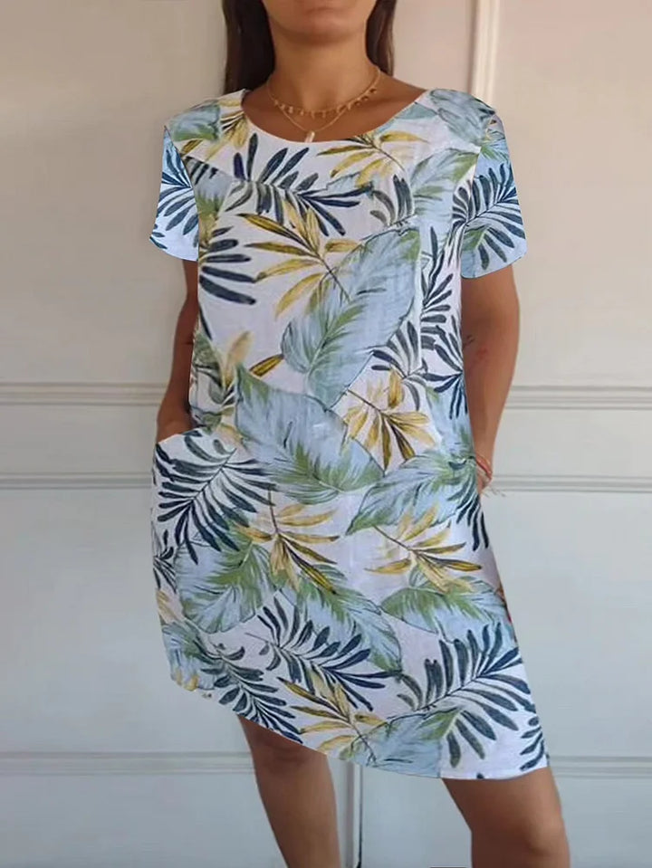 Frühlingshaftes Damenkleid mit floralem Print. Bequemes Kurzarm-Minikleid mit Taschen, ideal für Sonne & Freizeit.
