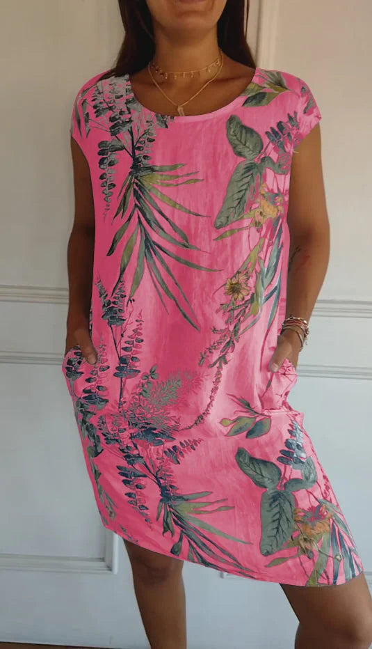 Stylisches Damenkleid mit Blumendruck, Rundhals, Kurzarm und praktischen Taschen. Vielseitiges Alltagskleid.