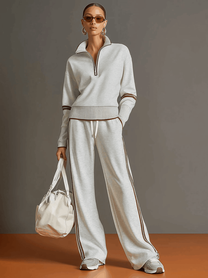 Stylisches Damen Vintage Loose-Fit Freizeit-Set: Halbzip-Pullover und weite Stoffhose in neutraler Farbe.