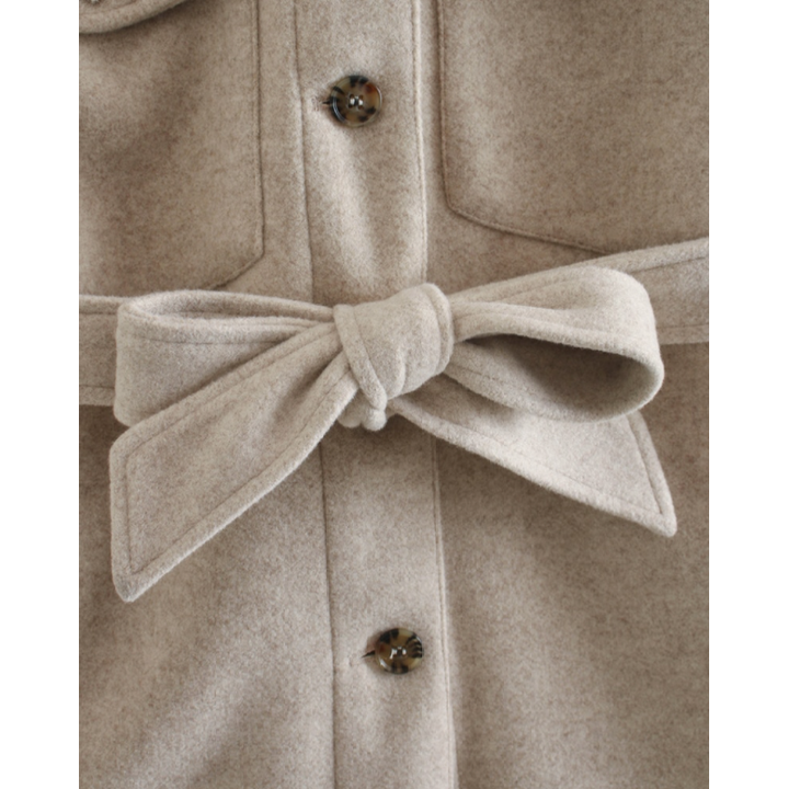 Rückenansicht des eleganten beigen Damenmantels mit Bindegürtel. Stilvolle Übergangsjacke für Damen.