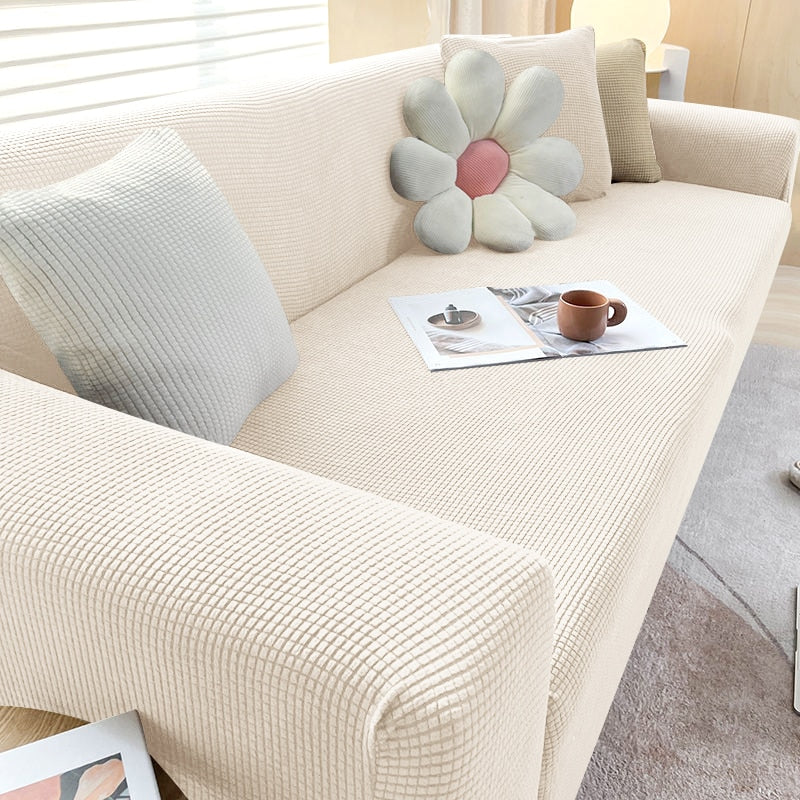 Dehnbare Sofahusse in Grau; elastischer Sofabezug für optimalen Schutz und neuen Stil im Wohnzimmer.