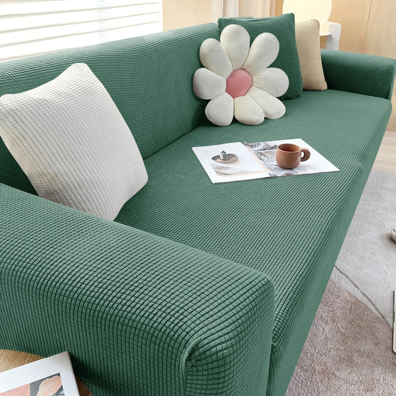 Türkise Stretch-Sofahusse; elastischer Möbelschutz gegen Schmutz und Abnutzung.