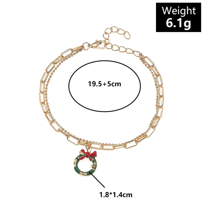 Festliches Damen Gliederketten Charme Armband, reich verziert mit verschiedenen Weihnachtssymbolen.