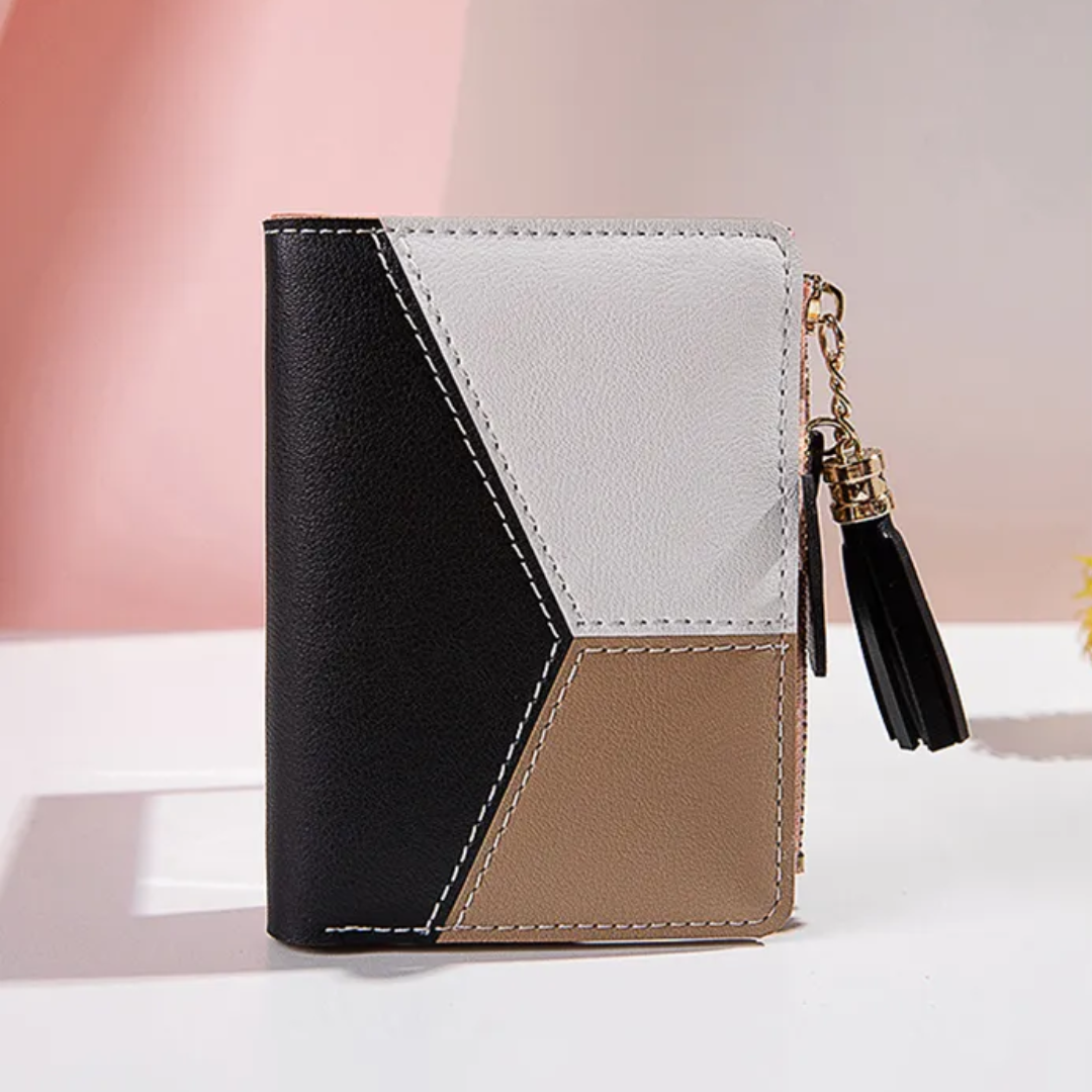 Elegantes Kurzportemonnaie für Damen, mit robustem Reißverschluss und modischer Quaste als Accessoire.