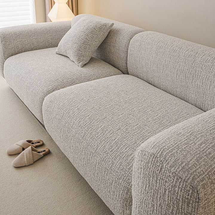 Bequemer, elastischer Chenille Sofaschutz in eleganter Farbe, ganzjährig nutzbar als stilvolles Wohnaccessoire.