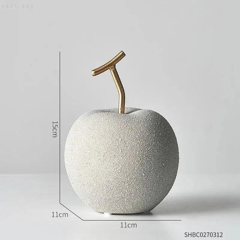 Set aus minimalistischen Apfel- & Birnen-Deko-Figuren aus goldfarbenem Harz für stilvolle Wohndekoration.