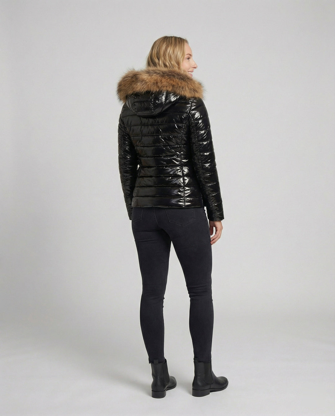 Stilvoller Damen-Puffermantel mit abgestepptem Design und warmer Pelzkapuze. Moderner Wintermantel, outdoortauglich.