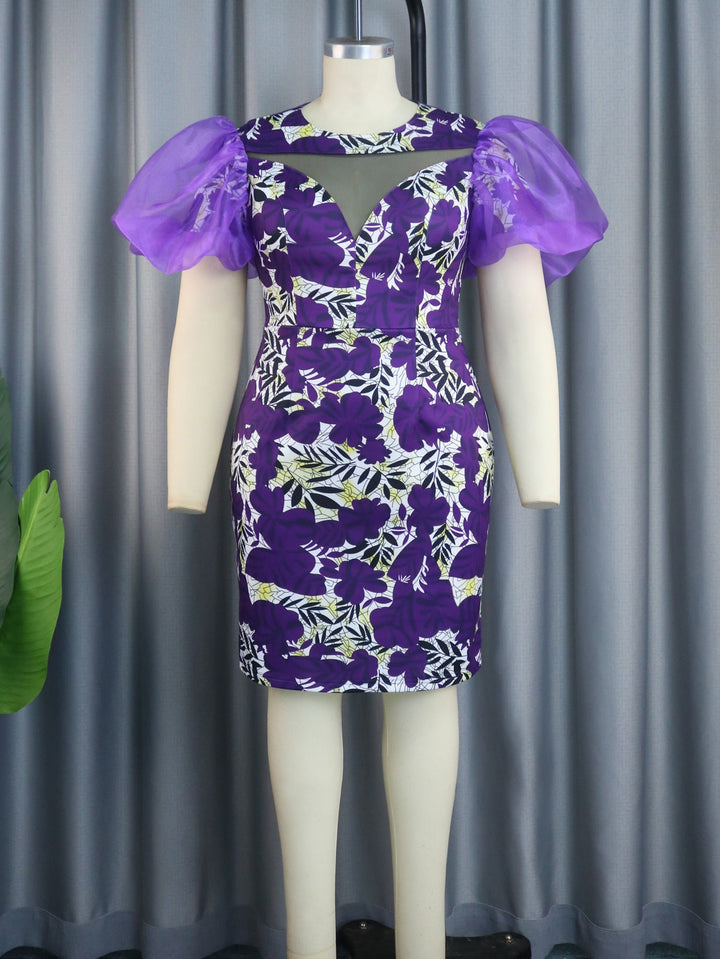 Elegantes Damen Festkleid in Lila, mit ansprechendem Blumenprint & schicken Puffärmeln, perfekt für Partys.