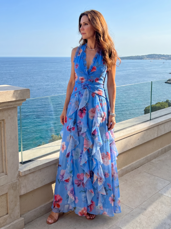 Fließendes Damen Halterneck Maxikleid mit charmantem Blumenmuster und femininen Rüschen.