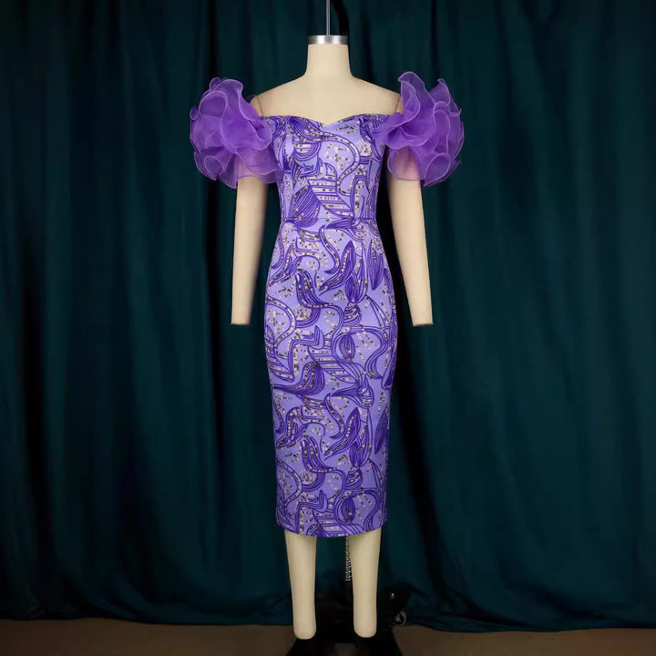 Damen Partykleid mit Kunstdruck, eleganten Puffärmeln & mittellanger Passform. Ideal für festliche Anlässe.