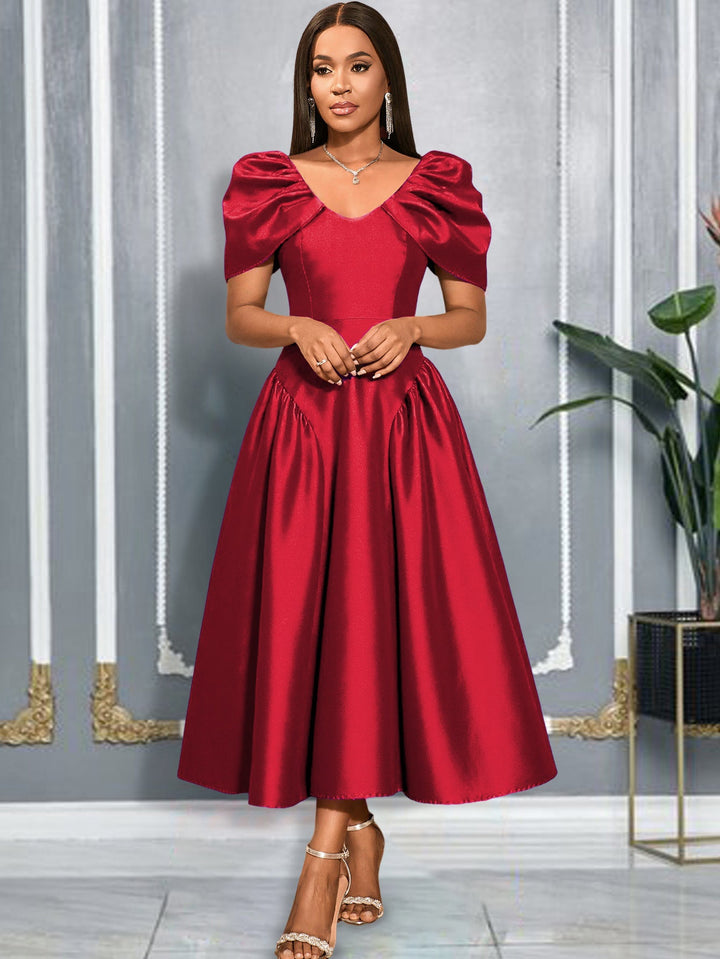 Stilvolles Midikleid für Damen mit voluminösen Puffärmeln und fließendem, schwingendem Rock, trendig.