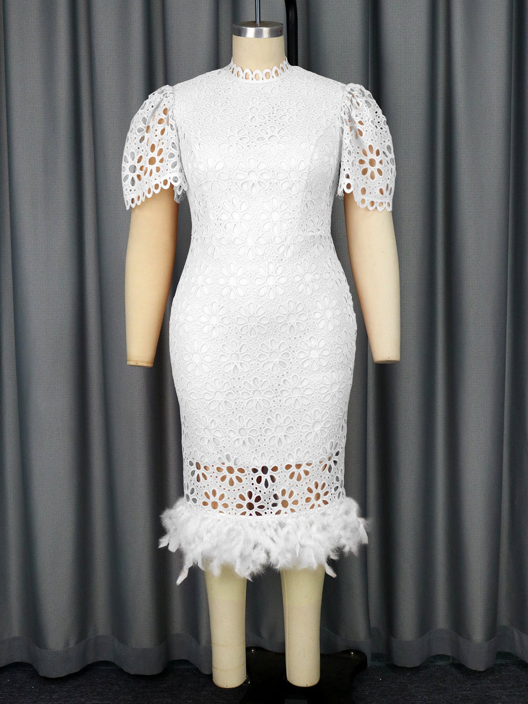 Feminines Damenkleid aus Spitze mit charmanten Puffärmeln und verspieltem Fransensaum, sehr elegant.