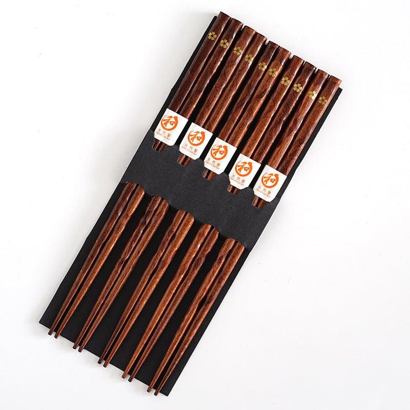 Traditionelle japanische Essstäbchen aus Holz mit Kirschblütenmotiv für authentische asiatische Tischkultur.