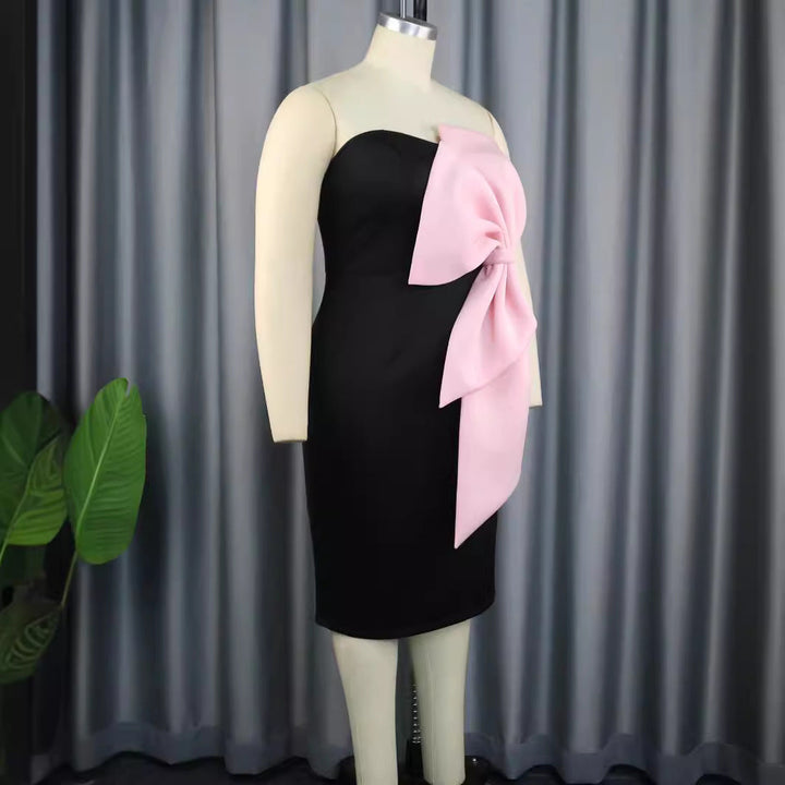 Modisches rosa Wickelkleid für Frauen, elegant schulterfrei und mit großer Schleife; ideal für besondere Feste.