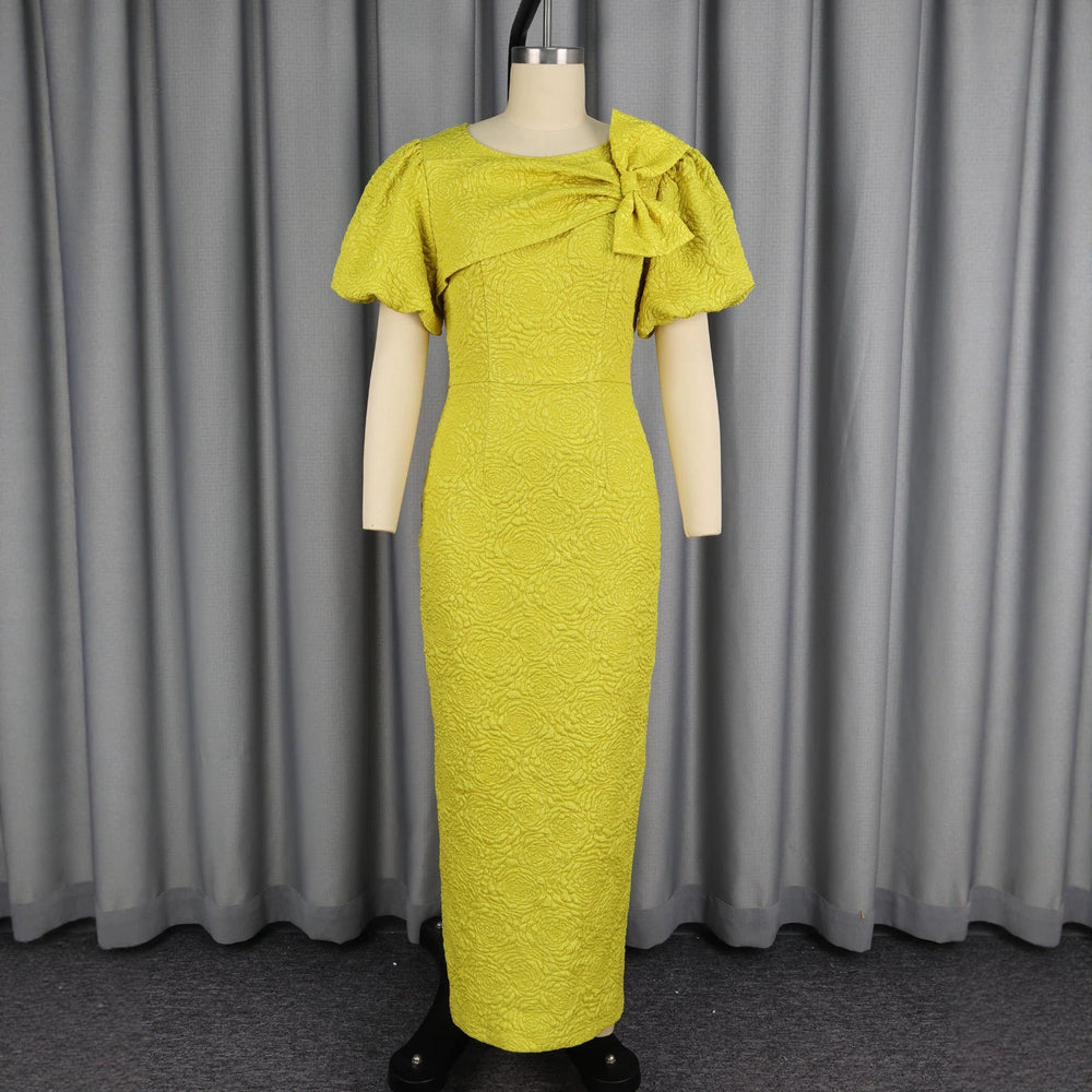 Stilvolles gelbes Maxikleid für Damen mit Puffärmeln & Schleife. Ideal als Abend- oder Anlasskleid, elegant & lang.