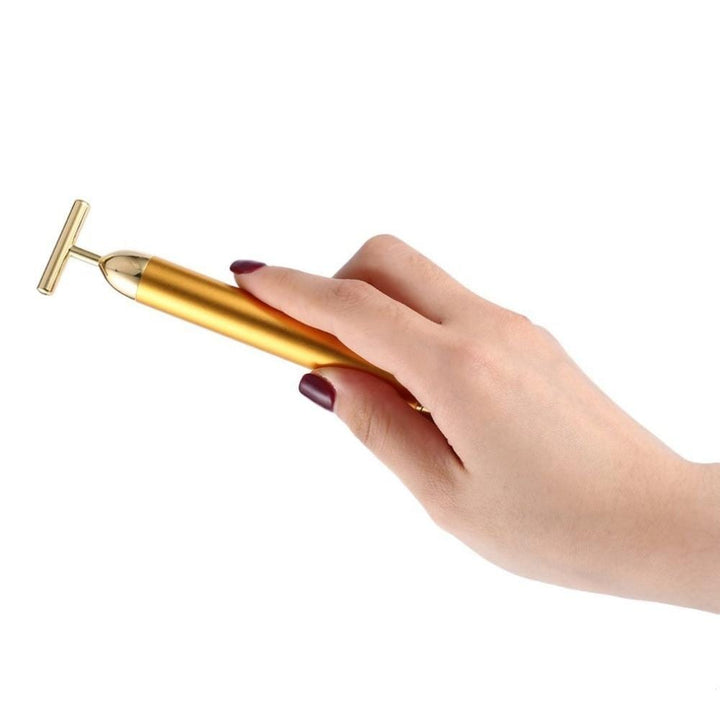 Luxuriöser goldener T-Bar Massager für Damen, ideal für tägliche Hautstraffung & Pflege.
