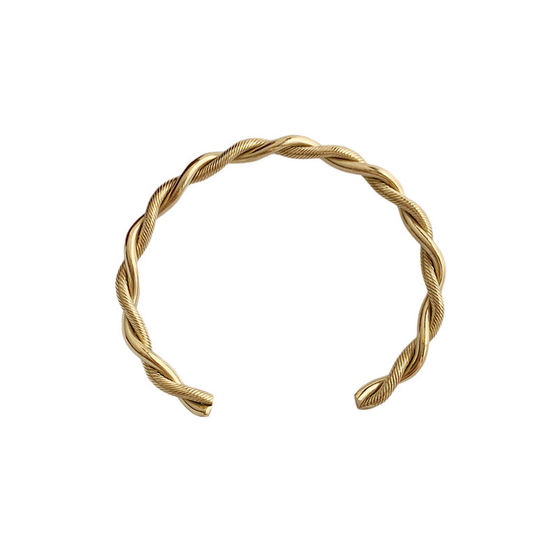 Stilvolles Damen Manschettenarmband mit Twist-Design aus Edelstahl, erhältlich in Gold oder Silber.