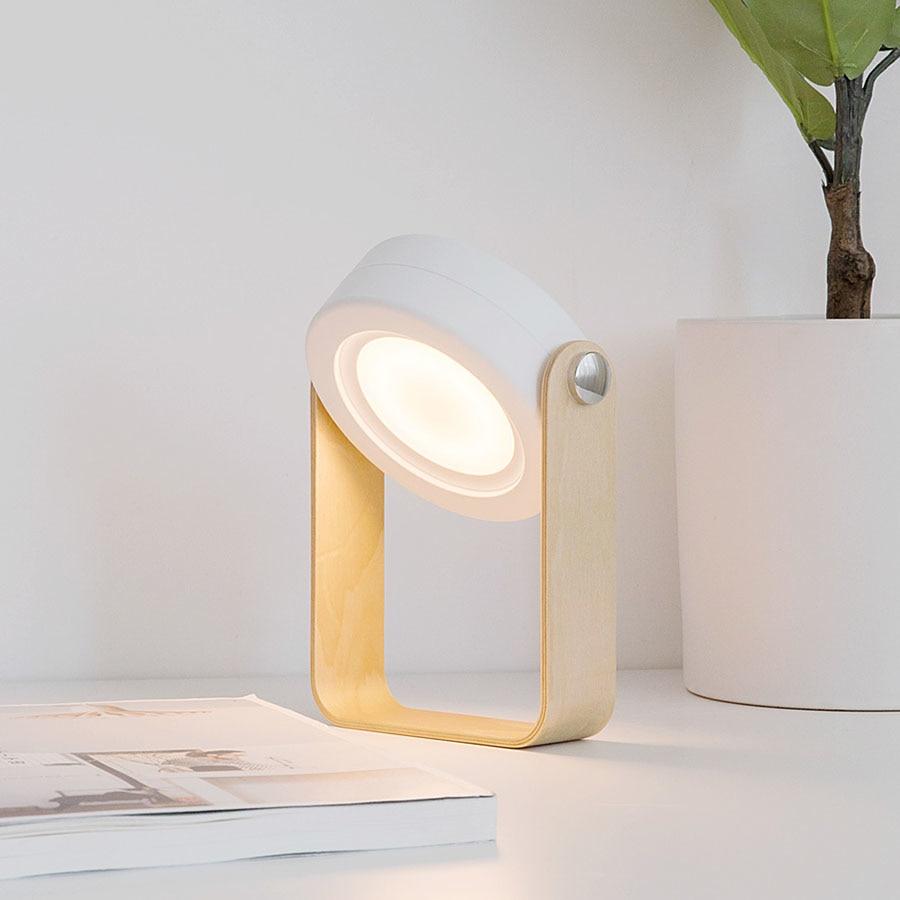 Weiße kabellose faltbare LED-Lampe, dimmbar warmweiß, perfekt als Nachttisch- oder Campinglampe.