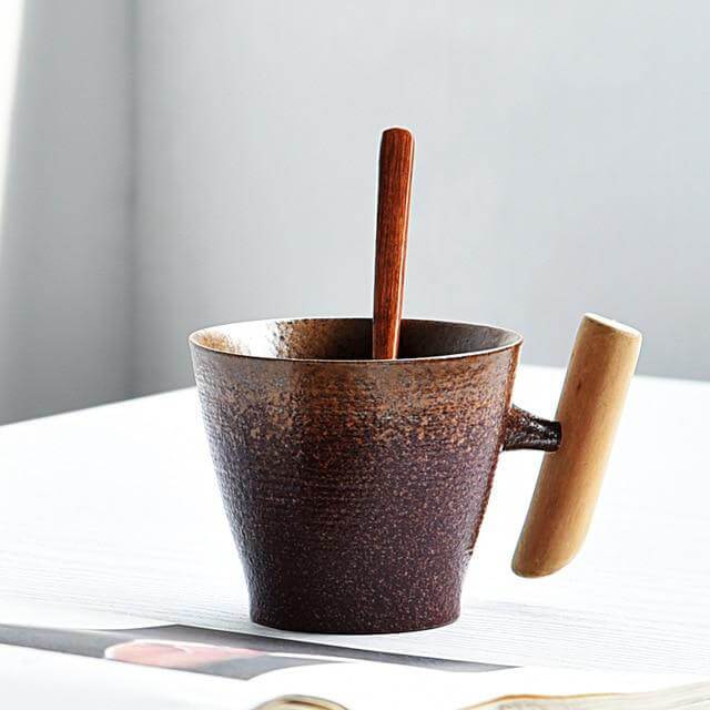 Rustikale Grobkeramiktasse, handgefertigt, mit natürlichem Holzgriff für authentischen Kaffeegenuss.