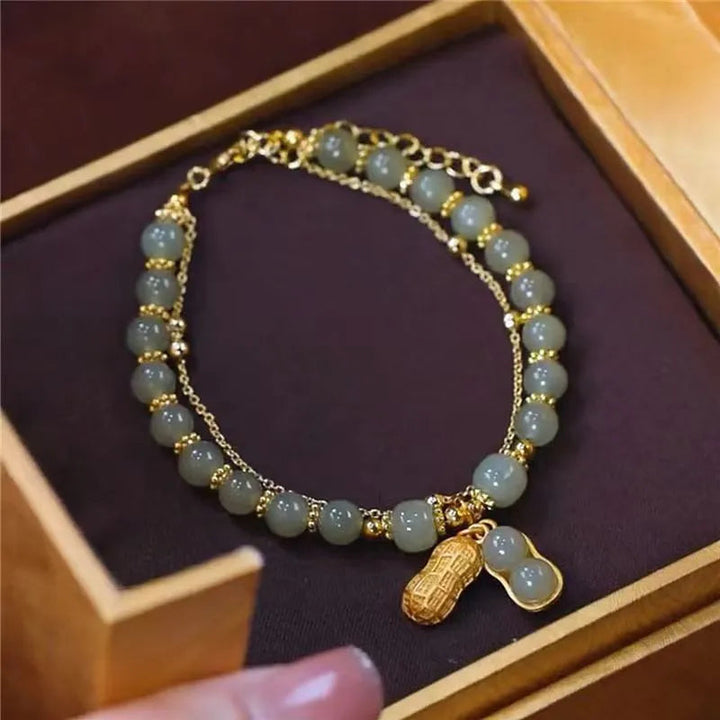 Hochwertiges Damen Armband aus Hetien Jade mit edlem Goldakzent, ein zeitloses Schmuckstück für jeden Anlass.