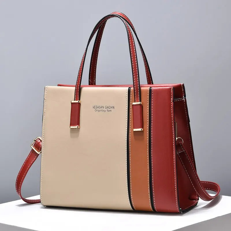 Farbenfrohe Damen-Handtasche im Patchwork-Design. Schultertasche in lebhaften Rot-, Rosa-, Khaki- und Grüntönen.