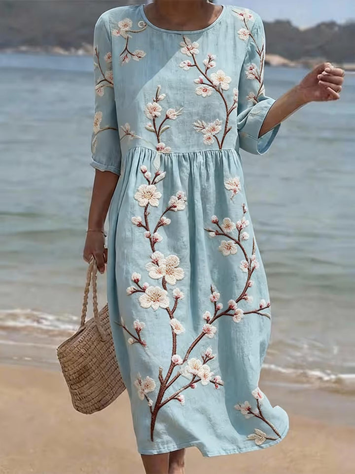 Hellblaues Damen-Midikleid mit eleganten Ellenbogenärmeln und lässigem Blumendruck, ideal für den Sommer.