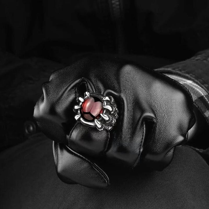 Eleganter Herrenring aus Edelstahl im Krallen-Design, mit tiefrotem Stein; stilvolles Modeschmuck-Accessoire.
