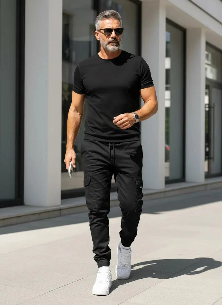 Mann trägt stylische schmale Cargo-Jogger, kombiniert mit T-Shirt, zeigt bequemen und modischen Freizeitlook.