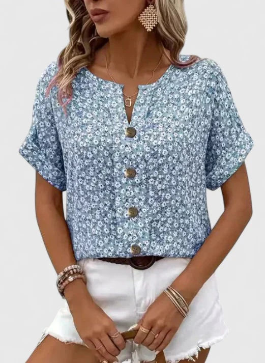 Kurzärmlige Damenbluse mit floralem Muster, ideal für warme Tage. Lockere Passform für Komfort und Eleganz.