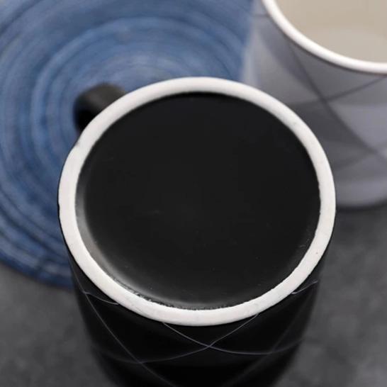 Nahaufnahme der modernen geometrischen Keramiktasse. Auffälliges Schwarz-Weiß-Muster für Kaffee und Tee.